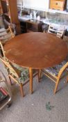 A teak drop leaf table and 4 chairs