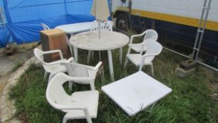 A white garden table, chairs, parasol etc