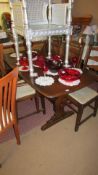 An oak refectory table, a single carver and 3 dining chairs