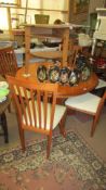 A circular dining table and 4 teak chairs