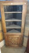 A Victorian oak corner cabinet