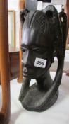 A carved hard wood African bust