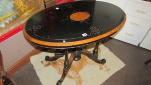 A Victorian oval ebonised table