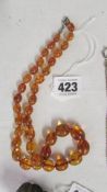 An amber coloured necklace