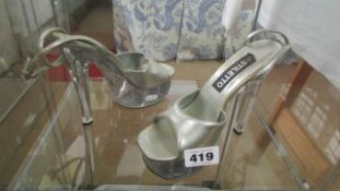 A pair of silver coloured 'Stiletto' shoes