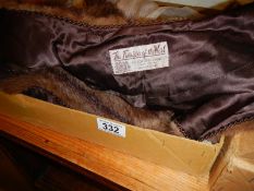 A fur cape in original box