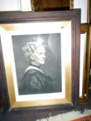 An engraving of a lady in oak frame