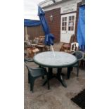 A garden table, 2 chairs & a parasol