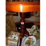 A mahogany tripod inlaid top table