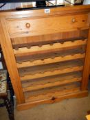 A large pine bottle rack with drawer
