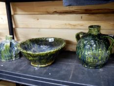 A shelf of art pottery