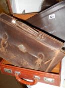 An old suitcase, briefcase and ships document folder