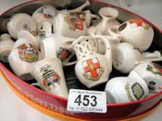 A tin tray of crested ware