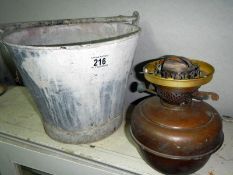 An old tin bucket & an oil lamp