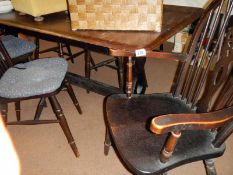 An oak table & 5 wheel back chairs