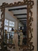 A large bevelled mirror in gilt frame