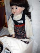 A large 20th c porcelain doll