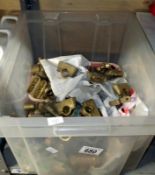 A crate of brass pipe brackets