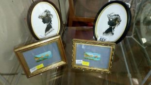 A pair of silhouettes and a pair of small painted plaques
