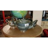 A silver plated teapot, milk and sugar bowl