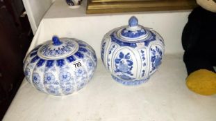 2 blue and white pots with lids