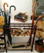 A Victorian walking stick stand and some sticks
