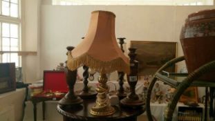 2 pairs of wooden candlesticks and a brass lamp