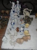 A quantity of dog figurines including poodles and other figurines