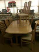 A large oak table with 8 chairs