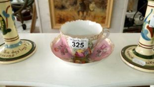 A handpainted cup and saucer