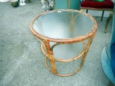 A glass topped round bamboo table