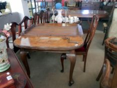A good Edwardian Queen Anne Leg wind out table and 2 chairs