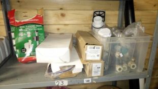 A shelf of miscellaneous plumbing items