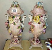 A pair of lidded majolica urns