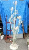 A unusual tall flower and petal lamp