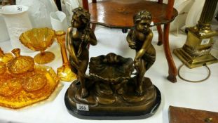 A large bronze of 2 children on a polished slate base marked A Carrier Belluse