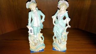 A pair of continental bisque porcelain figures