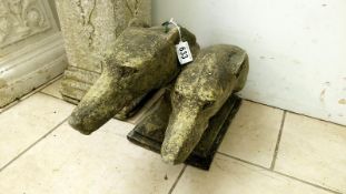 A pair of art deco style dog heads made in church stone