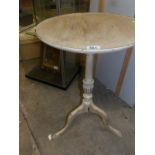 A shabby chic tripod table