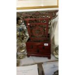 An Oriental back rest cabinet