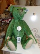 A boxed Steiff 1908 green teddy bear,