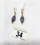 A pair of hall marked 325 gold tanzanite earrings