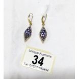 A pair of hall marked 325 gold tanzanite earrings