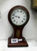 An inlaid mahogany balloon clock (over wound)