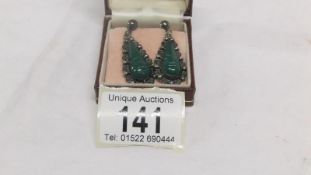 A pair of vintage pendant earrings in silver and with green stones