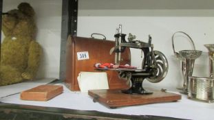 A vintage domed cased small lead machine sewing machine