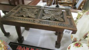 A carved oak foot stool