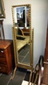 A gilt framed cheval mirror