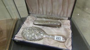 A cased white metal dressing set fashioned in the art nouveau style