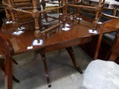 A mahogany drop side table